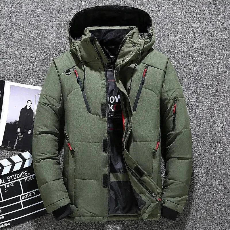 Jaqueta masculina parka acolchoada verde oliva com capuz, múltiplos bolsos frontais com zíperes vermelhos e pretos, e fechamento com botões de pressão e zíper, em um fundo que remete a um estúdio de cinema. Design robusto e funcional para um estilo de alta performance