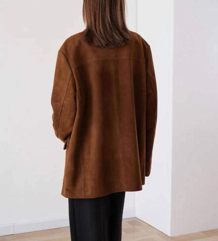 Parte traseira da jaqueta retro feminina de pele de carneiro marrom, exibindo a textura aveludada e o corte reto oversized, destacando a qualidade e o luxo discreto da peça de alto valor, ideal para o estilo de Embu das Artes.