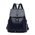 Mochila e bolsa feminina de couro 2 em 1 azul marinho, com aba frontal, fecho de gancho e bolsos laterais, design versátil com alças ajustáveis.