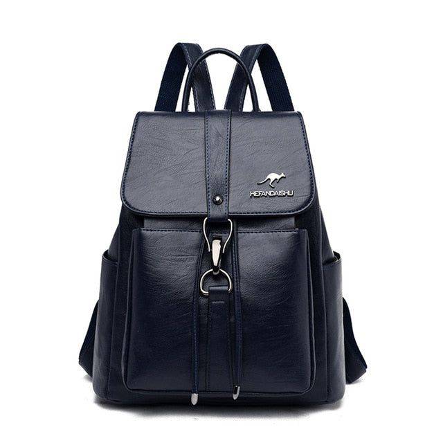 Mochila e bolsa feminina de couro 2 em 1 azul marinho, com aba frontal, fecho de gancho e bolsos laterais, design versátil com alças ajustáveis.